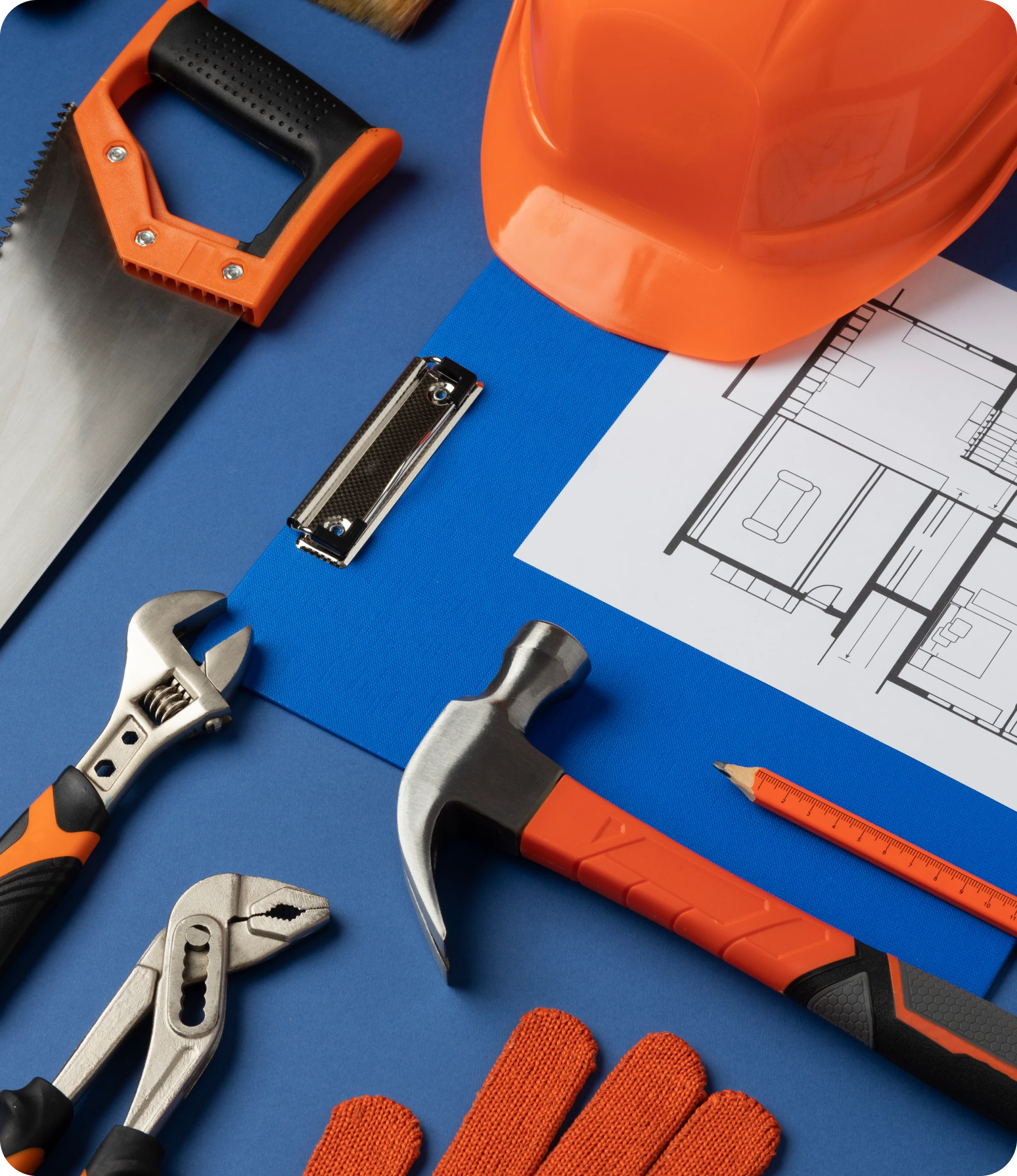 Hacksaw, Wrench, Pliers, Hammer, Hard Hat, Gloves, Blueprints On Blue Surface