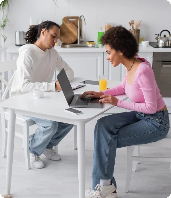 Couple working from kitchen representing home and family insurance lifestyle coverage